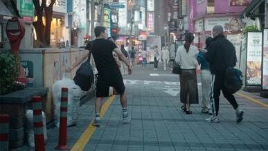 bustling urban street in evening with pedestrians