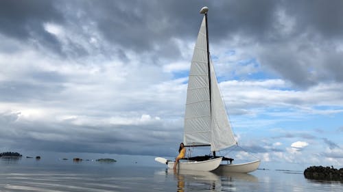 A Woman On a Sailboat At The Shore