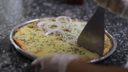 Person Slicing A Pizza