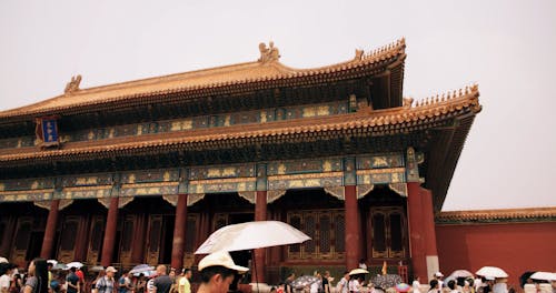 A Crowd Of Tourists Visits An Ancient Building In China