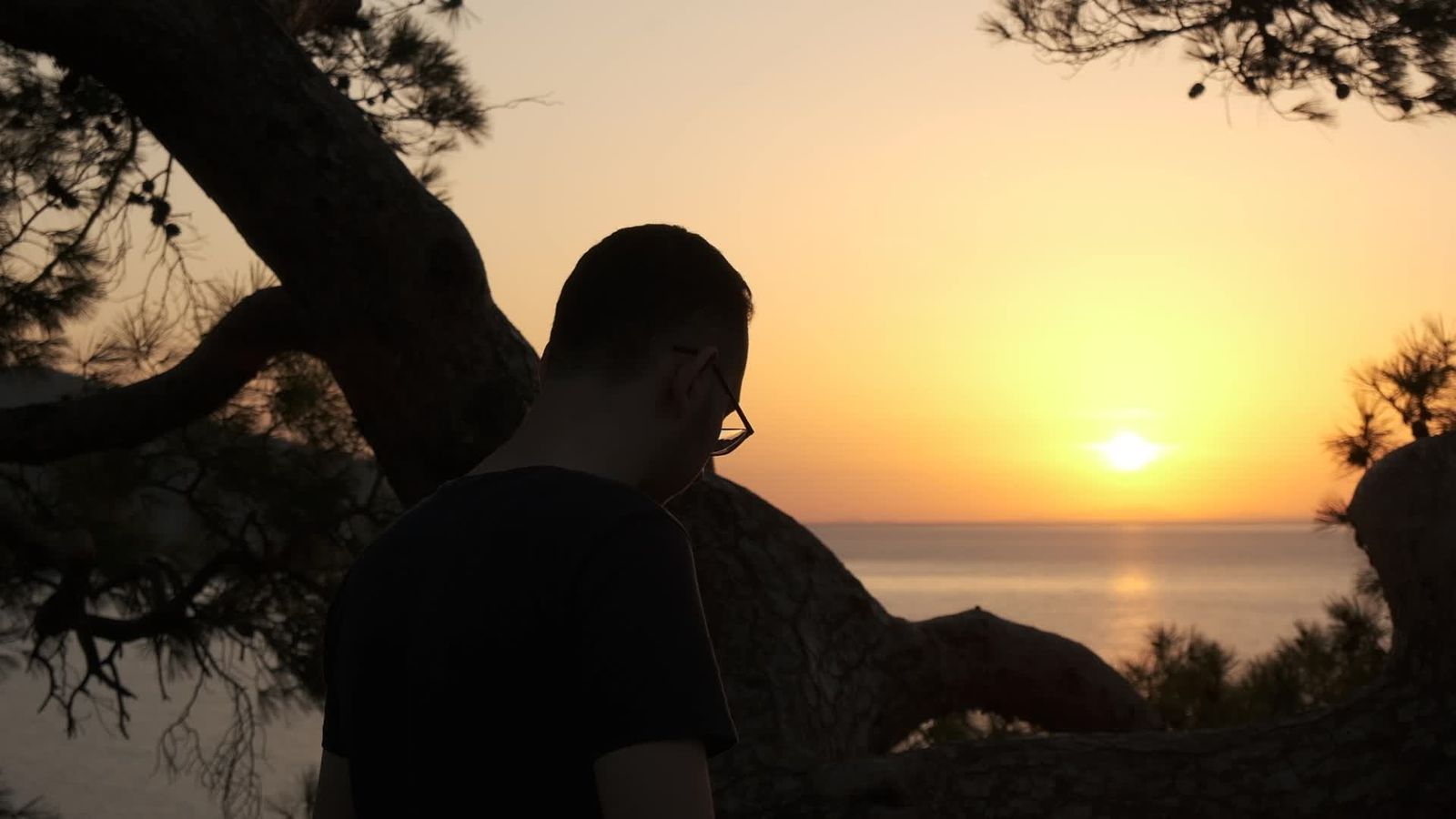 Contemplative Man Sitting by the Ocean at Sunset Free Stock Video ...
