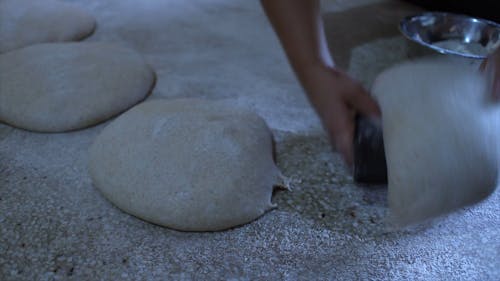 A Baker Skillfully Prepares The Dough For Baking