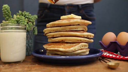 Pouring Honey On A Pile Of Pancakes