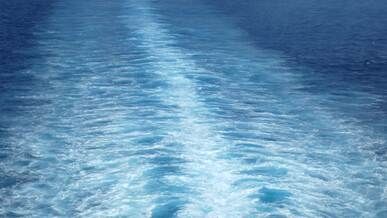 aerial view of ocean water with boat wake