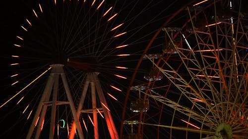 Lights Display Of Observation Wheel In Circular Motion At Night