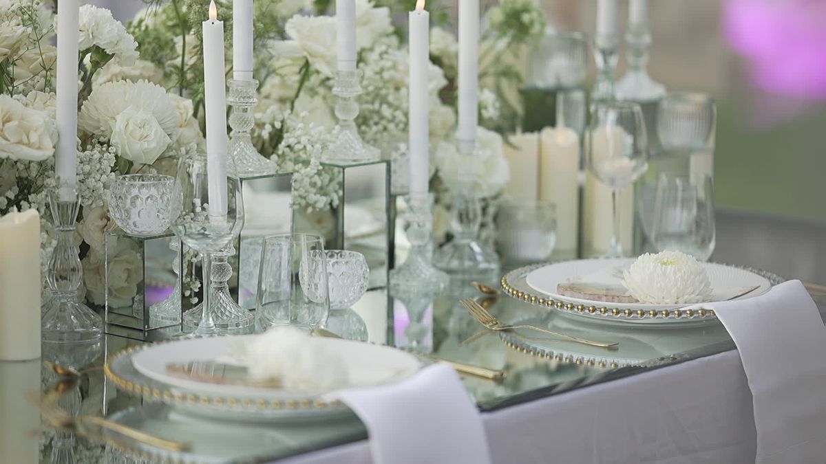 An elegant table setting with candles and white flowers — tablescape inspiration