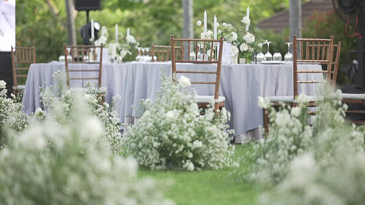 White floral arrangements at an outdoor wedding reception — floral styling inspiration