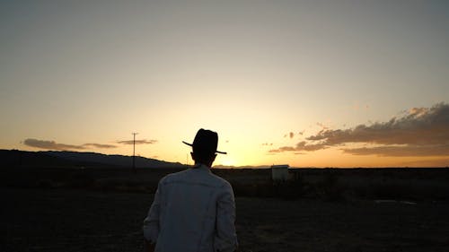 A Man Walking On A Barren Land