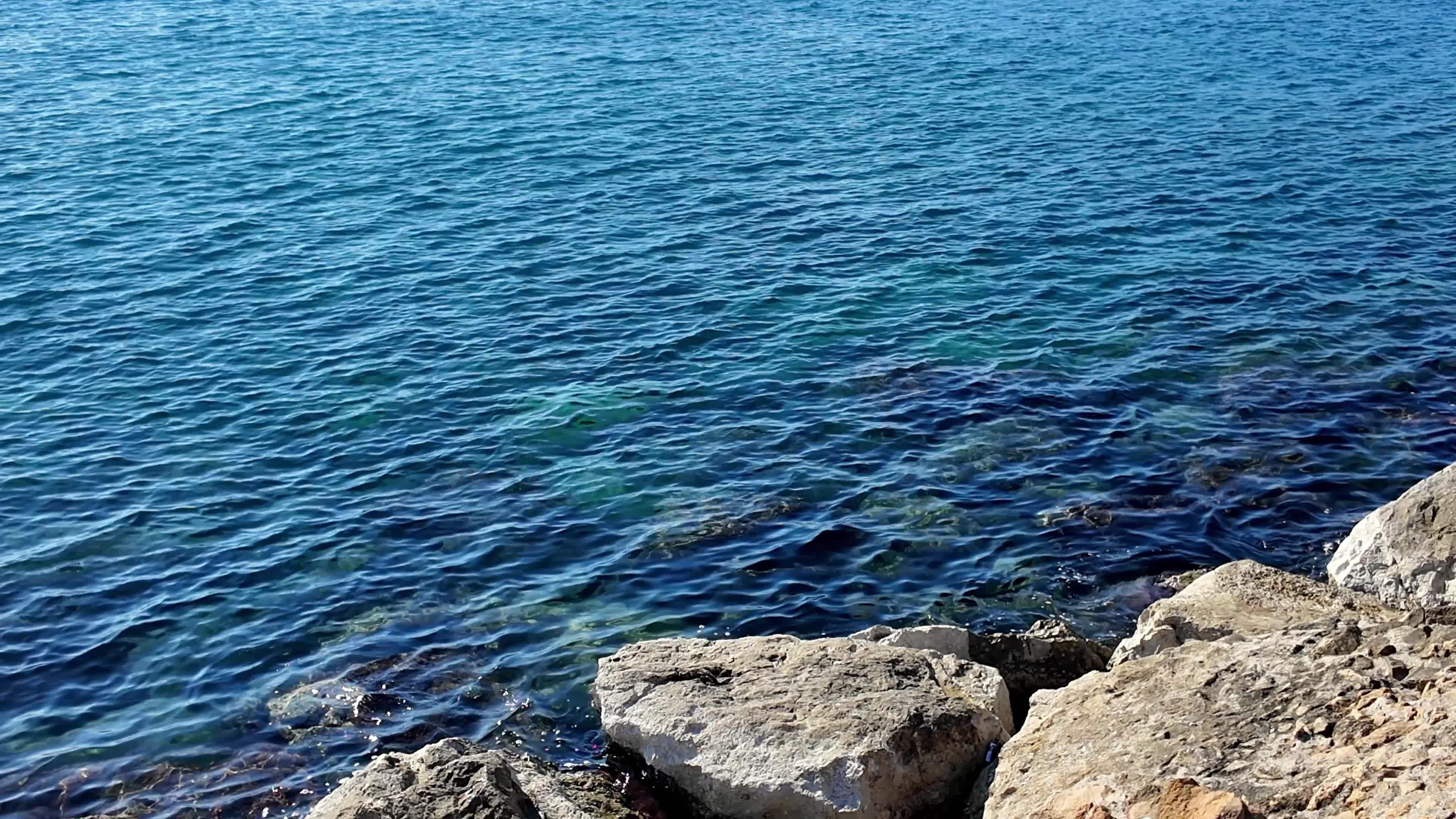 Tranquil Blue Ocean Waves Against Rocky Shoreline Free Stock Video ...