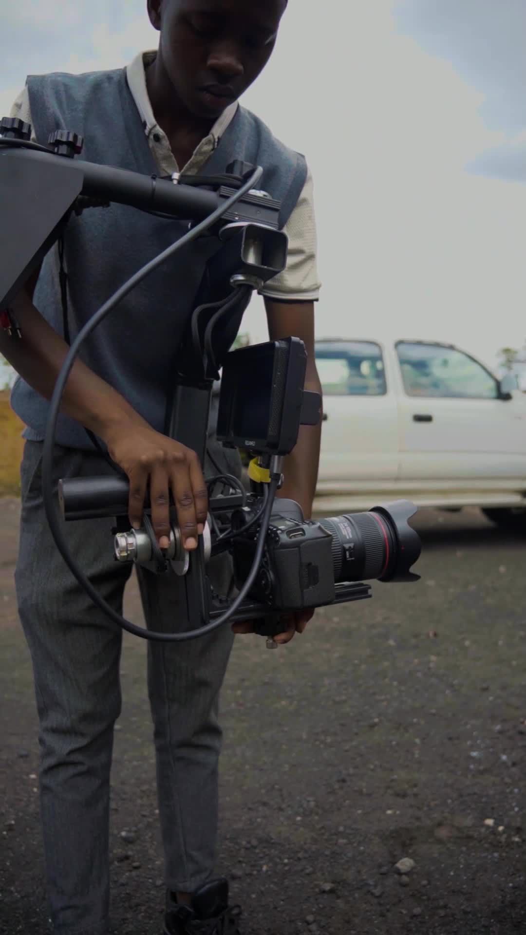 Videographer with a professional camera outdoors