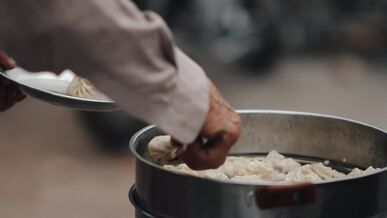 street vendor serving fresh dumplings