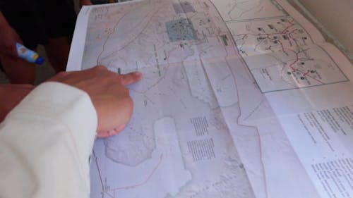 A Person Discussing Details Using A Map