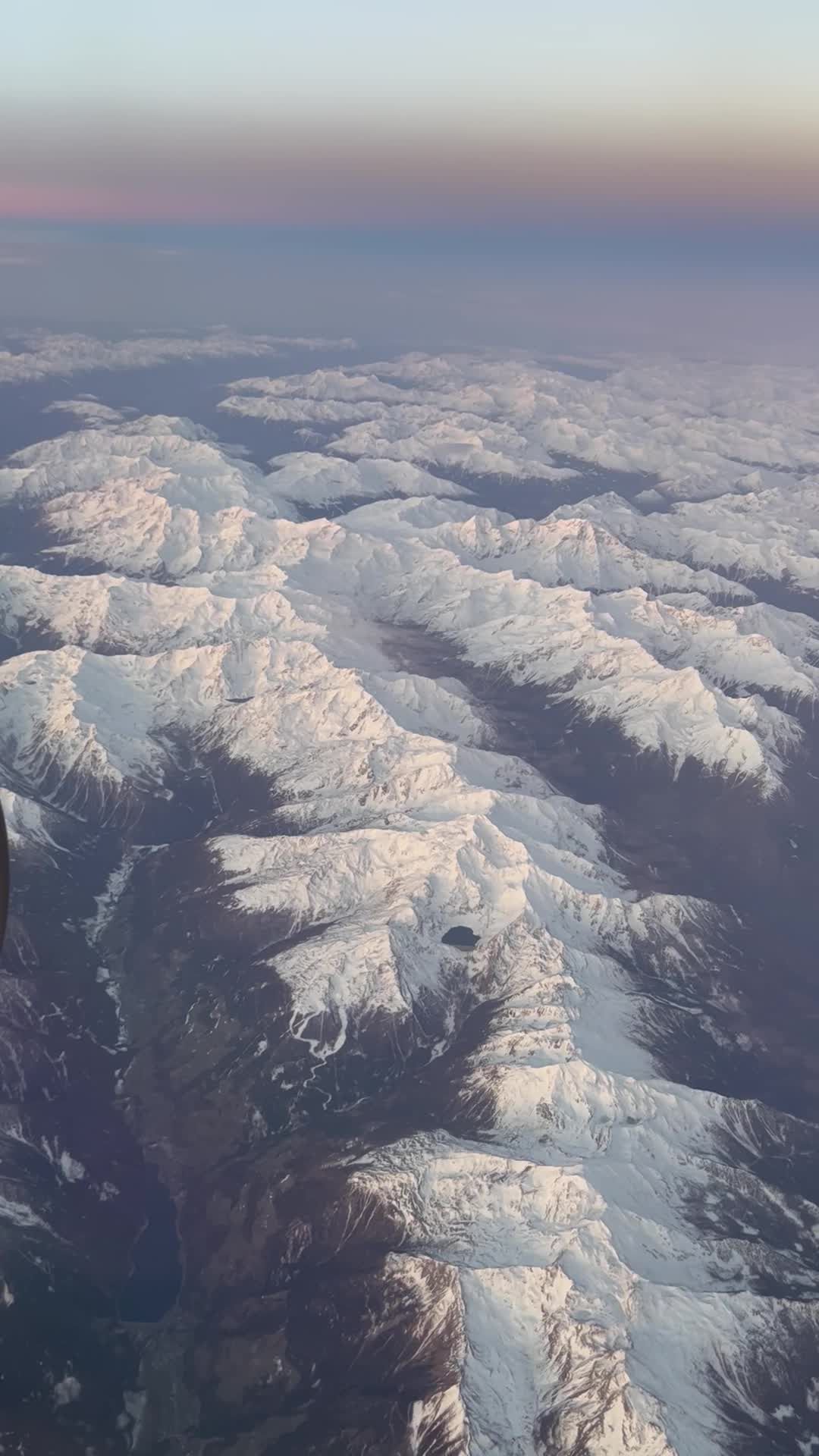 aerial view of snow capped mountain range at sunrise 30146916 — free pexels stock footage