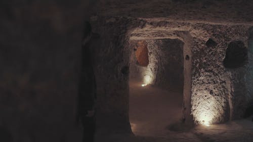Man Exploring Inside A Cave
