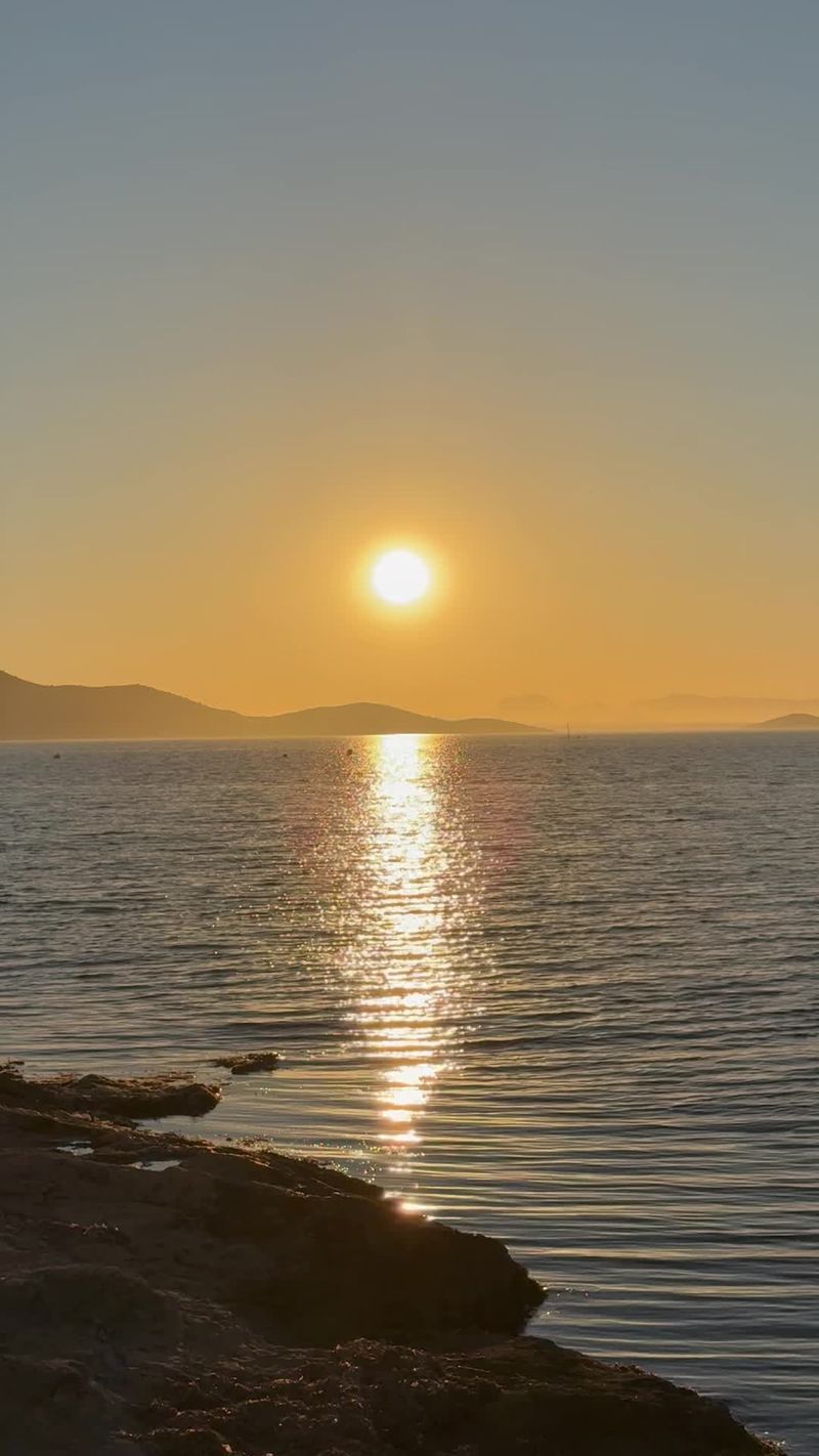 A person standing in front of the ocean at sunset Free Stock Video ...