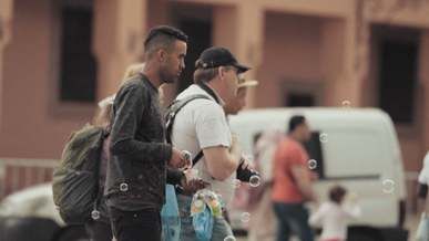 man selling soap bubble water gun on the street