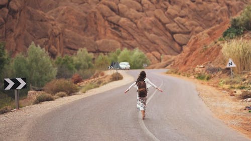 Woman Walking In The Middle Of The Road