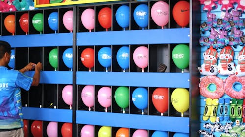 A Pop A Balloon For A Prize Game Attraction In An Amusement Park