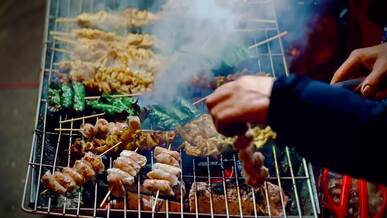street food bbq sizzling on grill