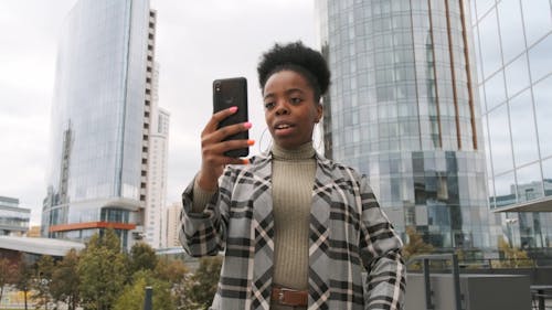 A Woman In A Video Call Outside Of A Building