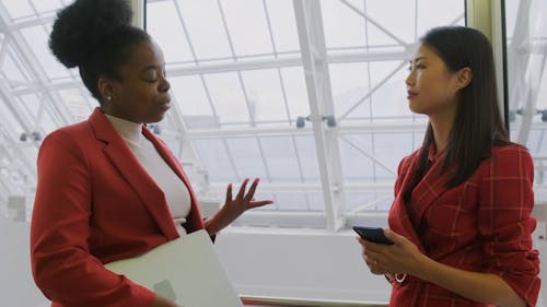 Two Women Talking Inside An Elevator Going Up