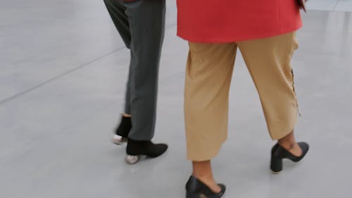 Two Women Walking Towards The Escalator To Go Up