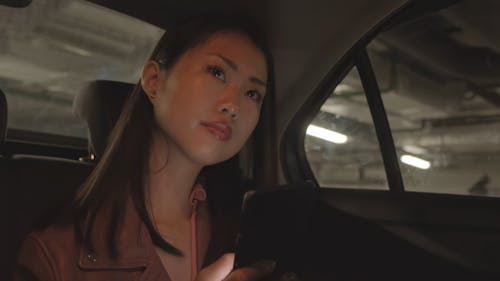 Woman Inside A Car Using Her Phone 
