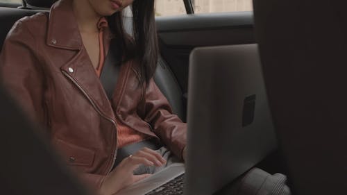 Woman Working With Her Laptop Inside The Car