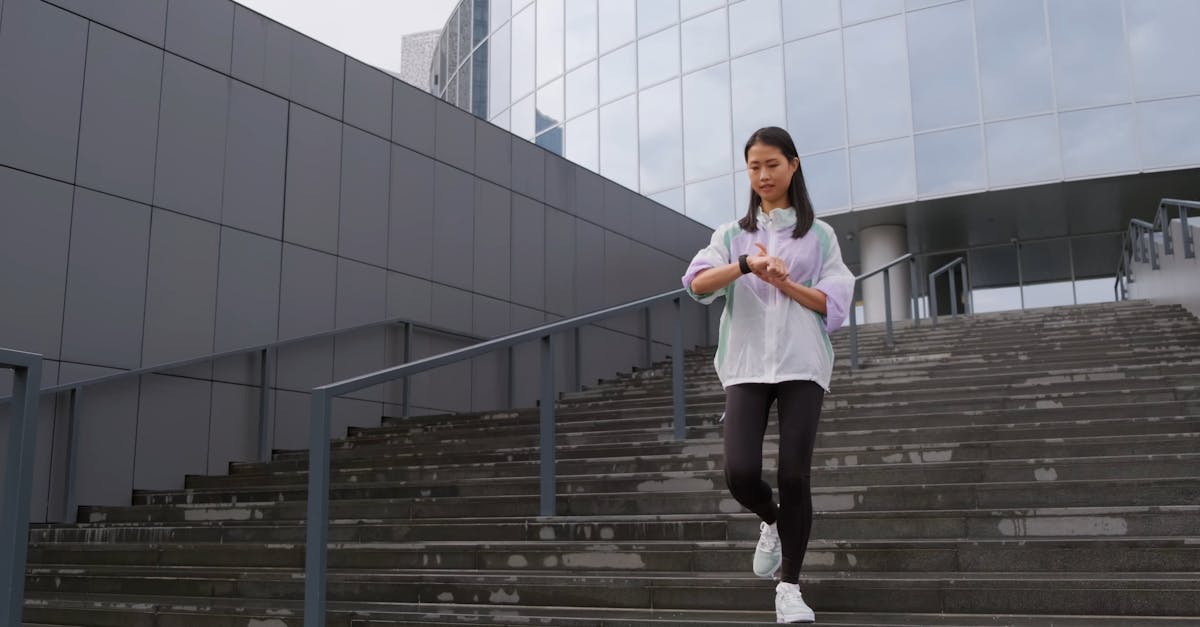 Woman Going Down The Stairs While Tracking Her Steps