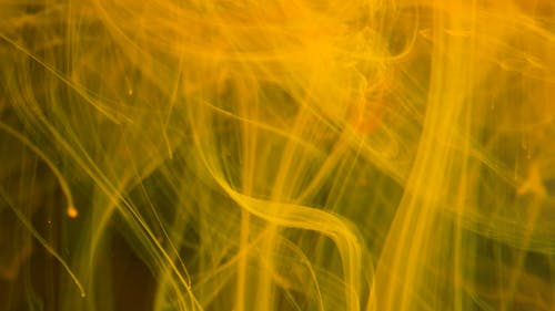 A Pastel Of Yellow Liquid Forms Different Patterns