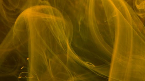 Yellow Smoke Flowing In Different Direction 