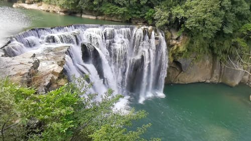 A Waterfalls Cascading Through Multi-layer Of Rocks Formation