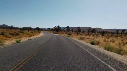 A Road Built For Travel In A Vast Desert Land