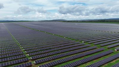 Aerial View of Expansive Solar Farm Under Cloudy Sky Free Stock Video ...