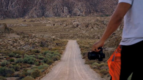 A Man Raising His Hand In Astonishment Of The Scenery In Front Of Him