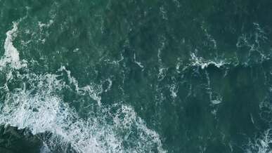 aerial view of ocean waves crashing