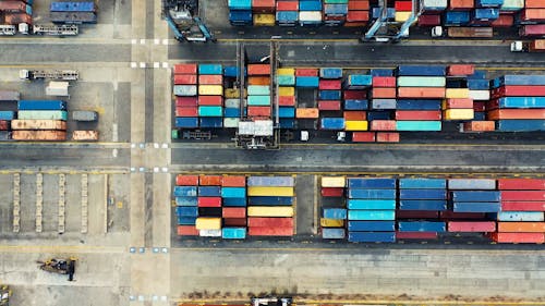 Cargo Containers Pile In Rows Inside A Sea Harbor
