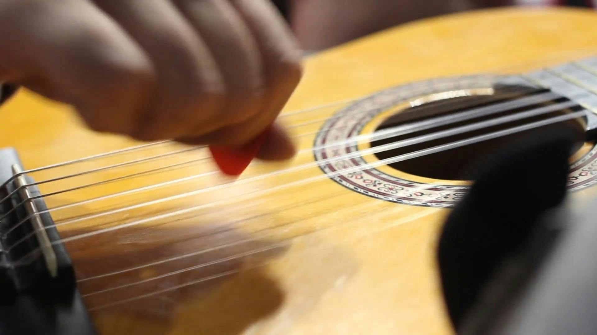 Strumming The Strings Of A Guitar With The Fingers · Free Stock Video