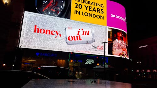 Low Angle footage Of Giant Led Billboards On A City Street At Night