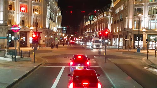 Vehicles At A Stop Light During Nightime