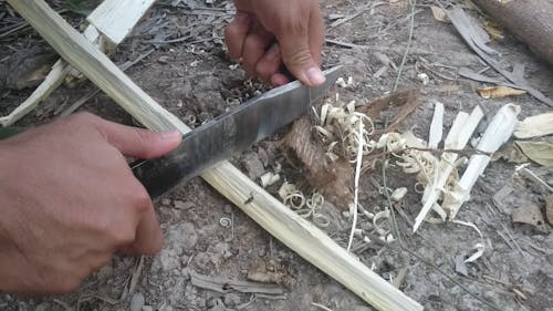 A Person Rubbing Two Metals To Make Fire