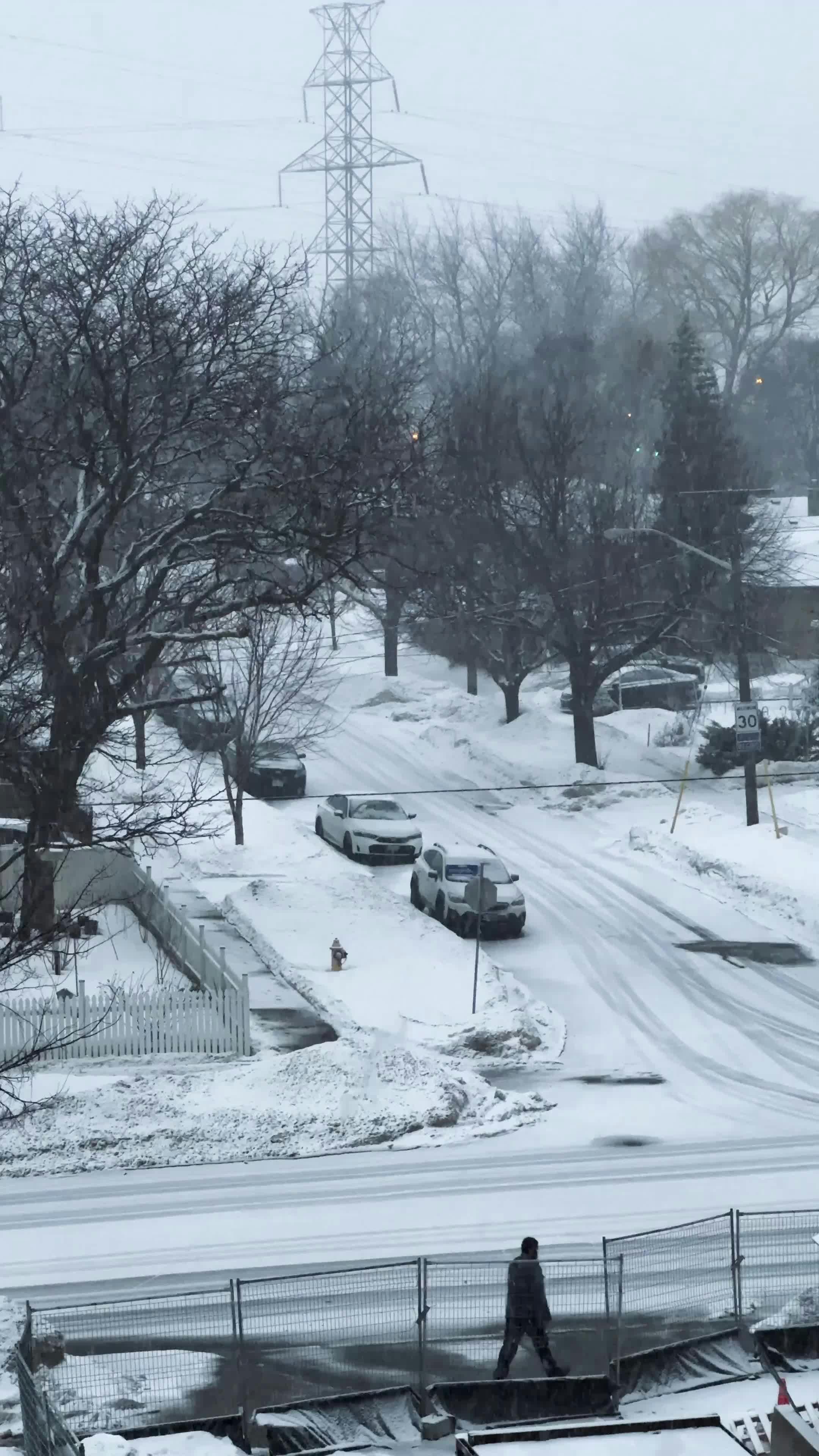 snowy urban street with passing school bus 31059900