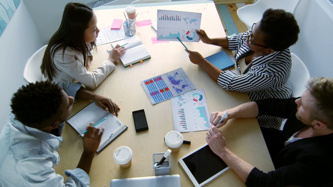 A delivery team working through ideas together in a modern office