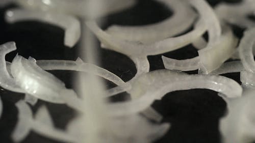 Close-Up View Of Onion Rings Being Fried