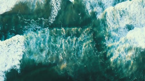 Series Of Waves Crashing The Beachfront 