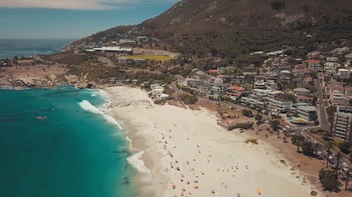 Una Multitud De Personas Disfrutando De La Playa En Un Día Soleado