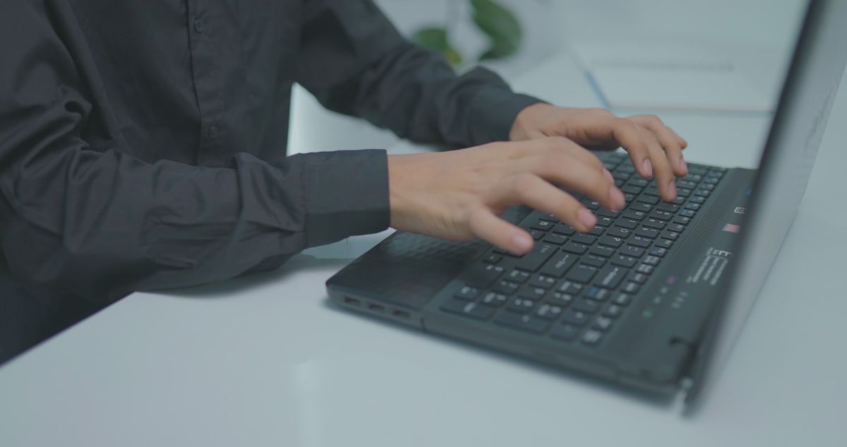 Woman Typing on Laptop in Office Setting Free Stock Video Footage ...