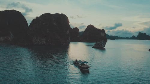 Two Boats On The Sea Besides The Rocky Hills Island Above Sea