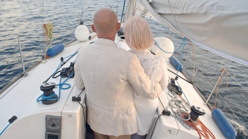 Backside Of A Couple In A Loving Embrace On A Seaborne Sailboat