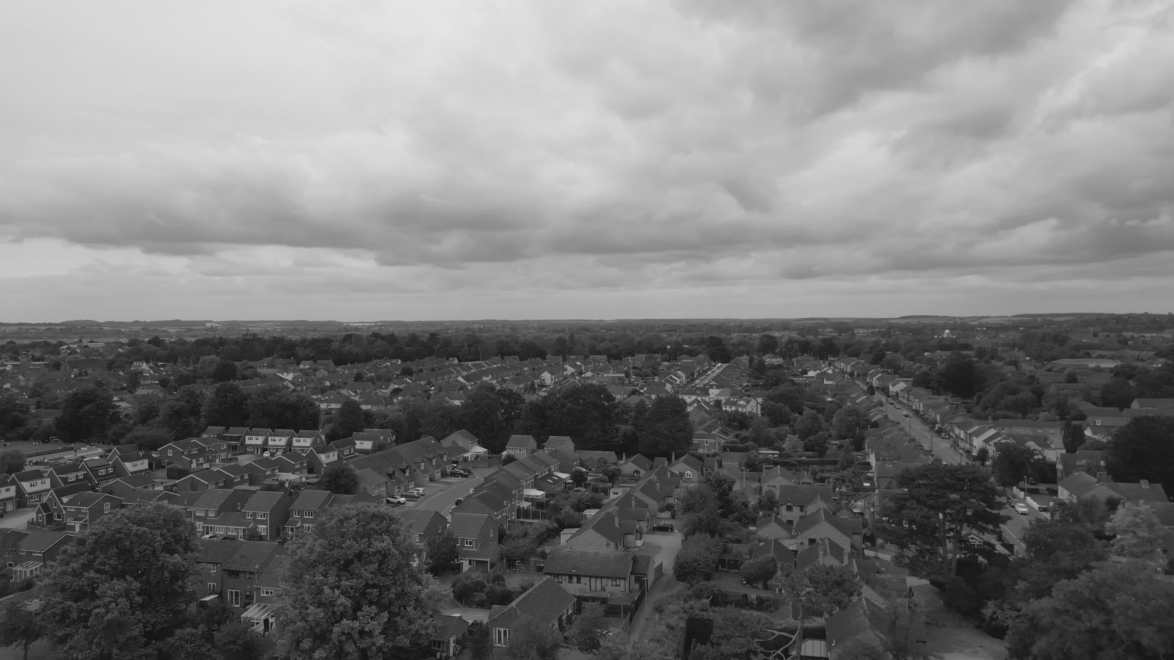 dramatic aerial shot of suburban homes under cloudy skies 31303944 — free pexels stock footage